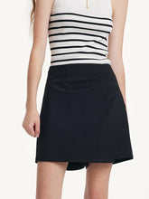 A lady wears a black skort.